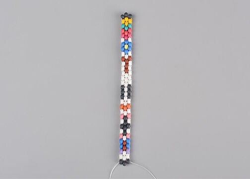 Three columns of multicolored seed beads, stitched together.